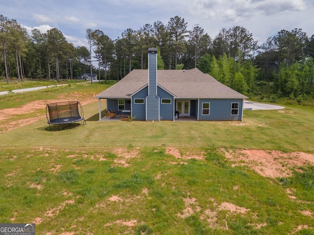 296 Beavers Rd, Grantville, GA 30220 - back of house with a trampoline, a chimney, a yard, and a patio