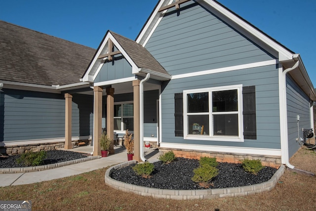 view of front of property with covered porch and roof with shingles