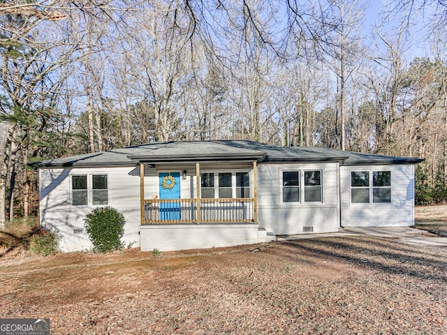 single story home featuring crawl space, a porch, brick siding, and roof with shingles