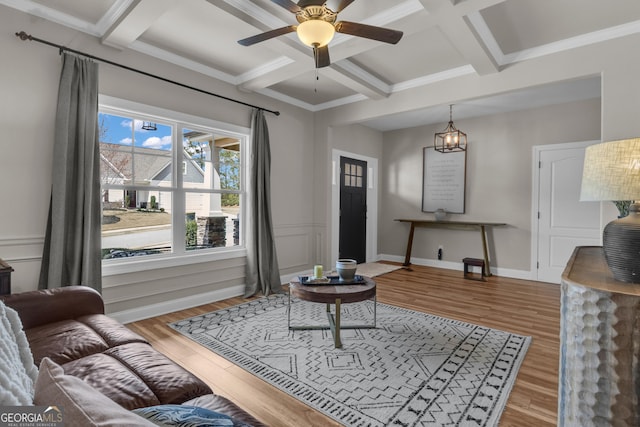 living room with beam ceiling, coffered ceiling, wood finished floors, and a ceiling fan