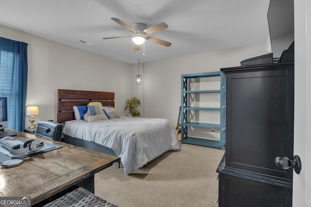 bedroom with visible vents, light carpet, and a ceiling fan