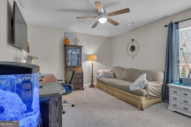 home office with visible vents, baseboards, a ceiling fan, and carpet floors