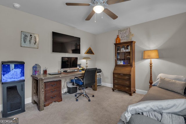 carpeted office featuring baseboards and ceiling fan