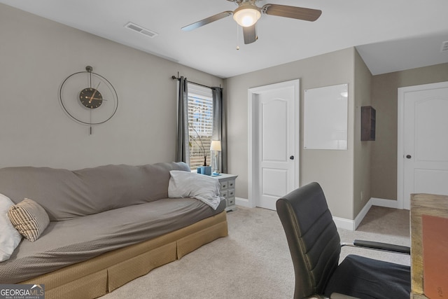 office featuring visible vents, baseboards, light colored carpet, and ceiling fan