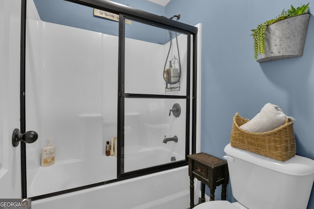 bathroom featuring shower / bath combination with glass door and toilet