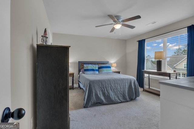 bedroom with carpet flooring, baseboards, visible vents, and ceiling fan