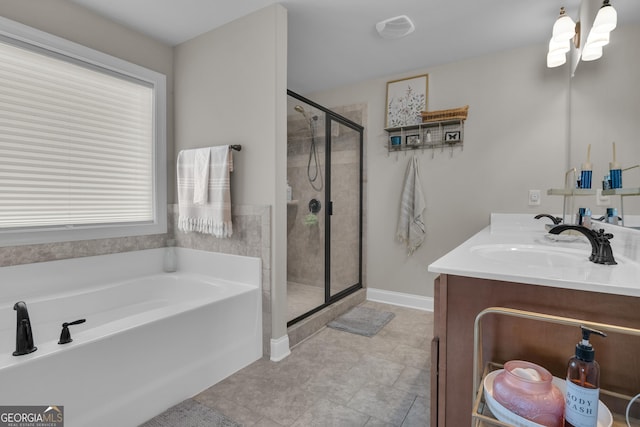 full bathroom with baseboards, double vanity, a sink, a shower stall, and a garden tub