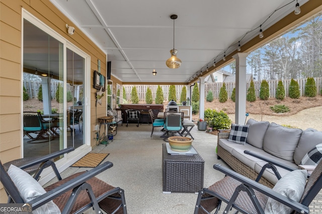 view of patio / terrace with outdoor dining area, fence, and an outdoor hangout area