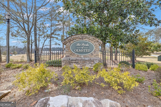 community sign featuring fence