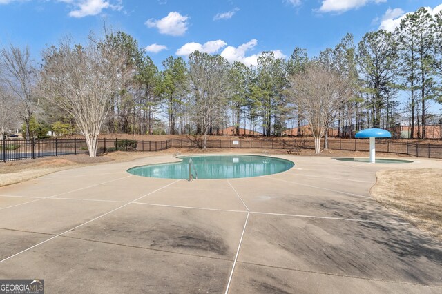 view of pool with a fenced in pool, a patio area, and fence