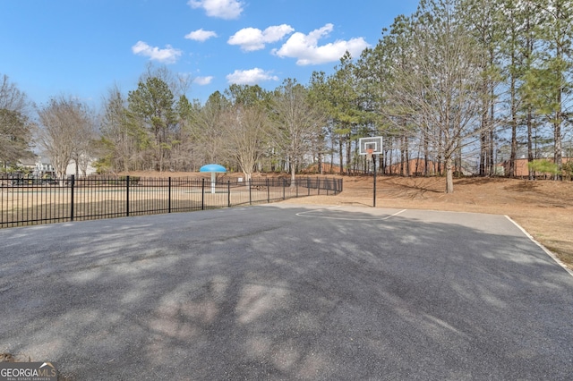 view of basketball court featuring community basketball court and fence