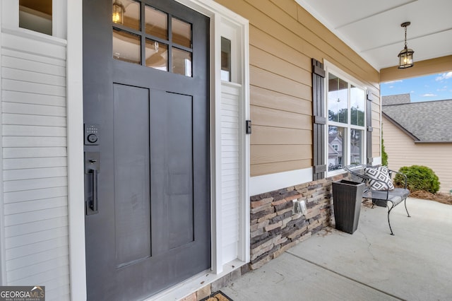 view of exterior entry with covered porch