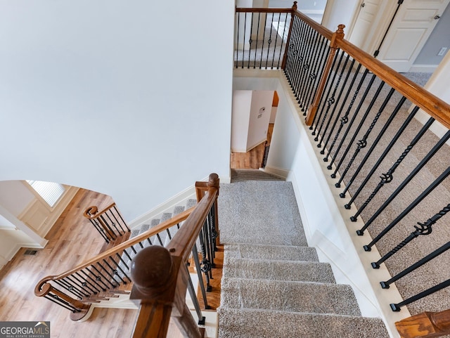 stairway with wood finished floors