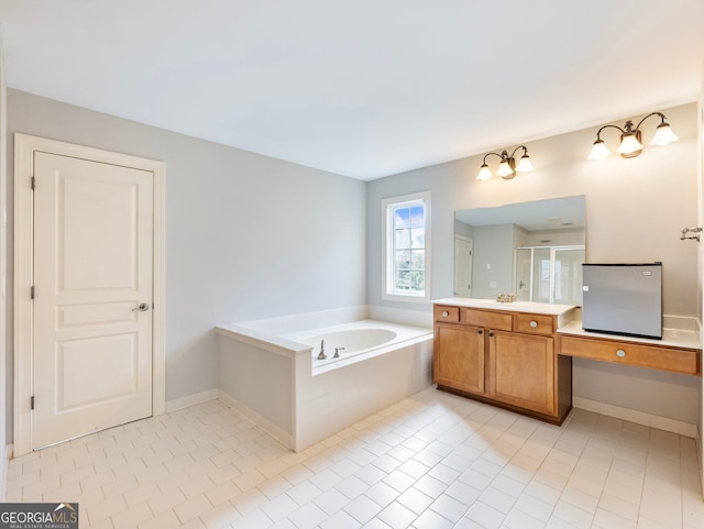 full bathroom with tile patterned floors, a garden tub, a stall shower, and vanity