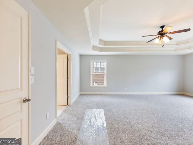 2536 Kachina Trl, Dacula, GA 30019 - empty room with light carpet, a tray ceiling, ornamental molding, and a ceiling fan