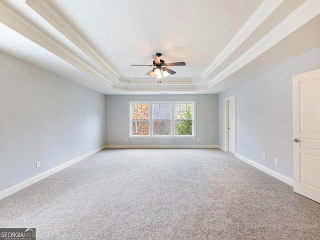 empty room featuring light carpet, crown molding, a raised ceiling, and a ceiling fan