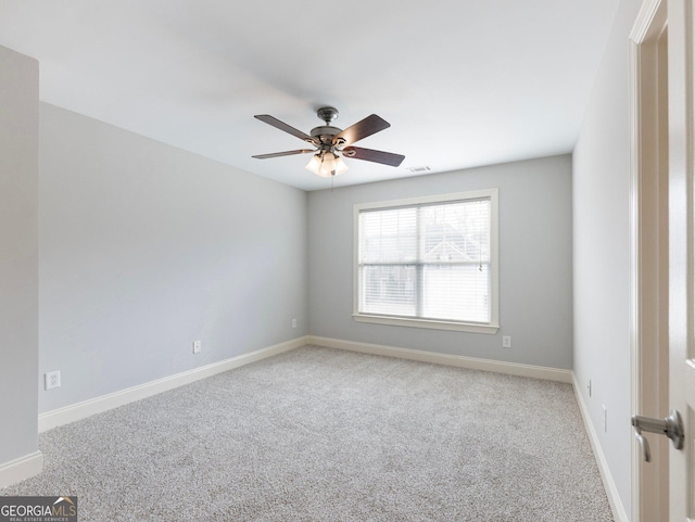 spare room with visible vents, a ceiling fan, baseboards, and carpet floors