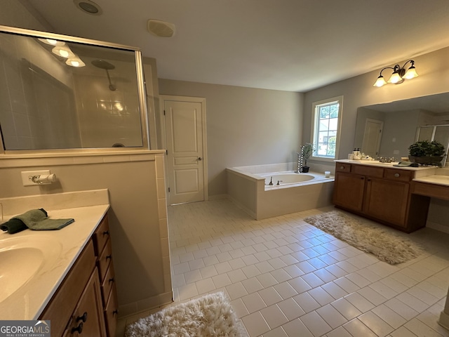 full bath with a garden tub, a stall shower, a sink, two vanities, and tile patterned flooring