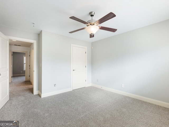 unfurnished bedroom with visible vents, light colored carpet, and baseboards