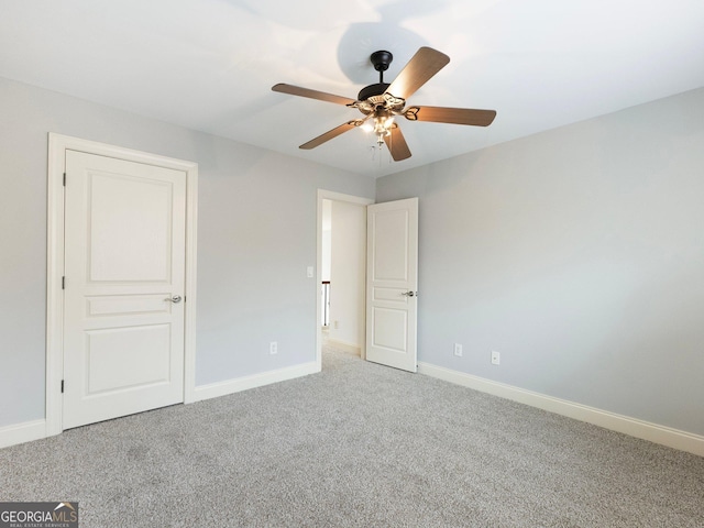unfurnished bedroom featuring carpet flooring, baseboards, and a ceiling fan