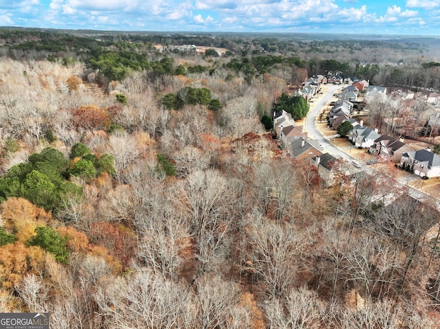 drone / aerial view with a wooded view