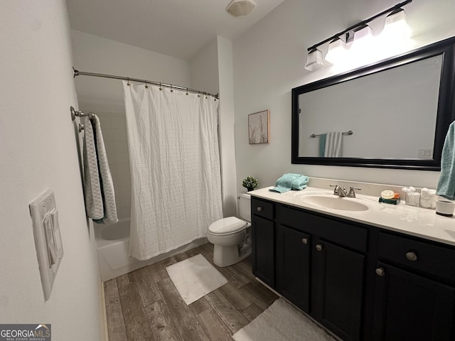 bathroom with toilet, vanity, shower / bath combo, and wood finished floors