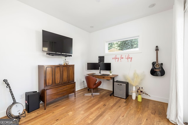 office area with light wood finished floors and baseboards