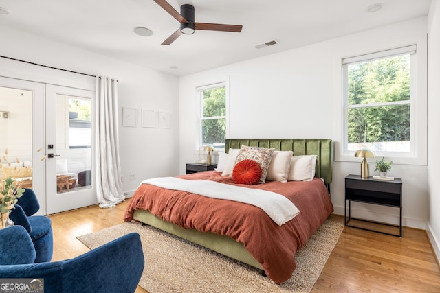 bedroom with access to outside, baseboards, visible vents, and light wood finished floors