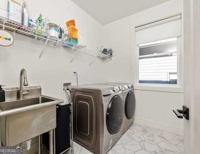 laundry area featuring marble finish floor, a sink, separate washer and dryer, baseboards, and laundry area