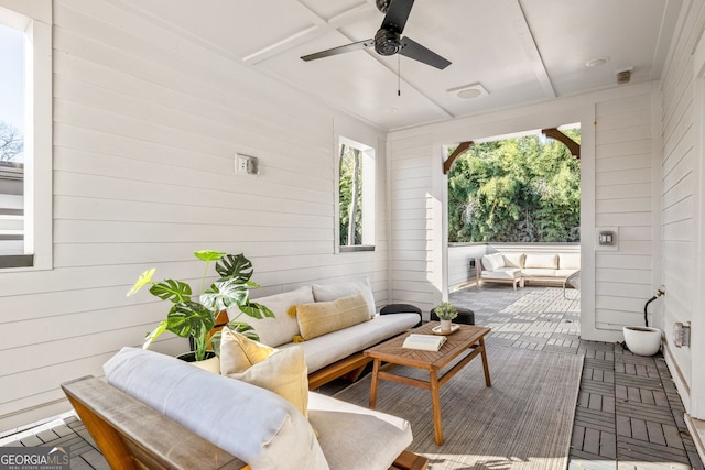 wooden terrace featuring visible vents, an outdoor hangout area, and ceiling fan