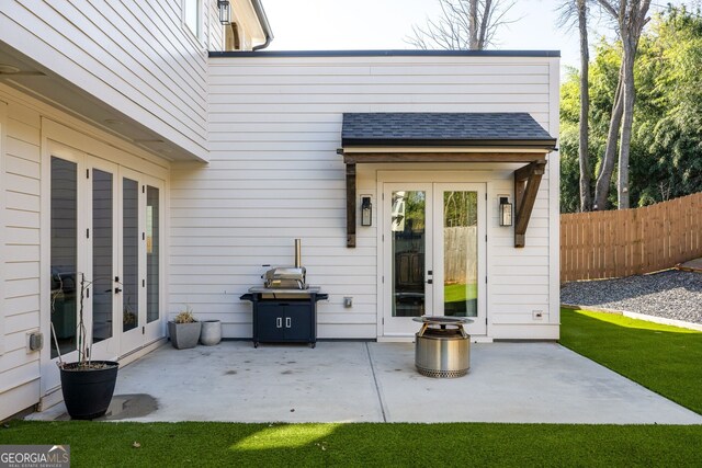 view of patio featuring french doors and fence