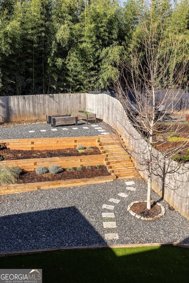 view of yard featuring a vegetable garden and a fenced backyard