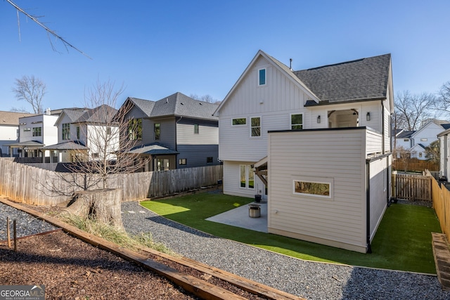 back of property with board and batten siding, a residential view, roof with shingles, a lawn, and a patio