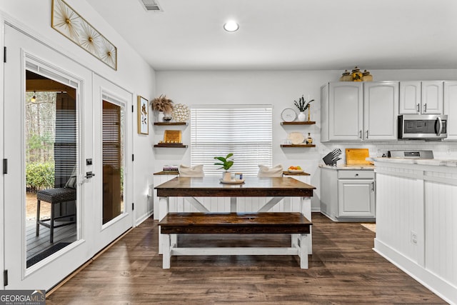 dining room with dark wood finished floors, plenty of natural light, and french doors