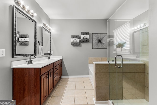 full bath with tile patterned flooring, double vanity, a bath, and a sink