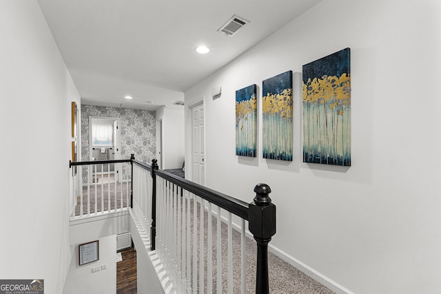 hall featuring recessed lighting, an upstairs landing, visible vents, and baseboards