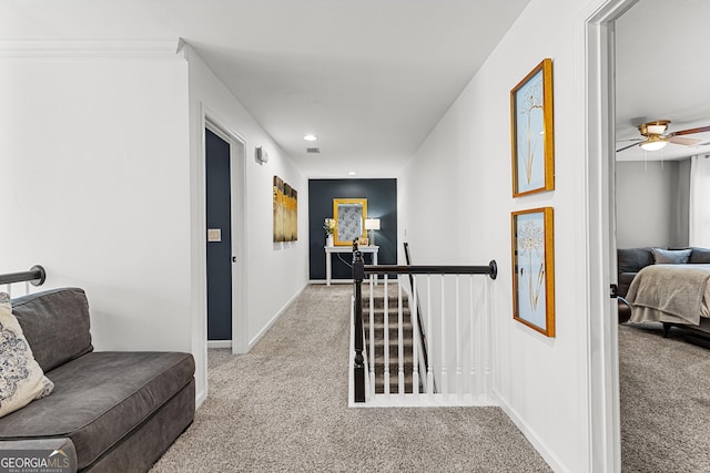 corridor featuring recessed lighting, an upstairs landing, baseboards, and light carpet