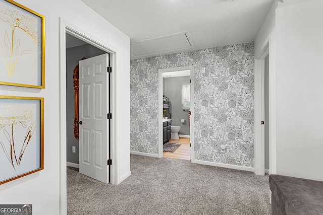 corridor with baseboards and carpet flooring