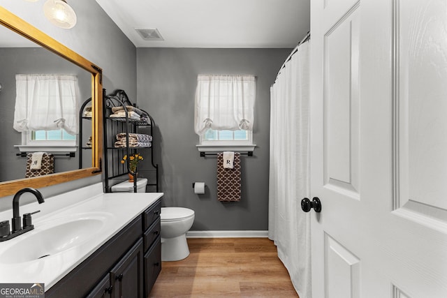 bathroom featuring a wealth of natural light, visible vents, wood finished floors, and vanity