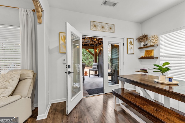 doorway to outside featuring dark wood-type flooring, french doors, visible vents, and baseboards