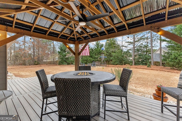 wooden deck with a gazebo and an outdoor fire pit