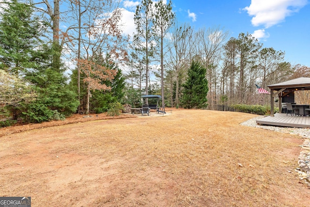 view of yard featuring a gazebo, a fire pit, and a deck