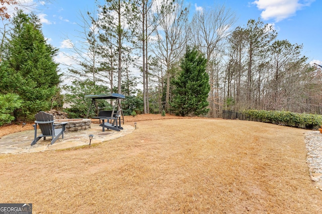 view of yard with a patio and an outdoor fire pit