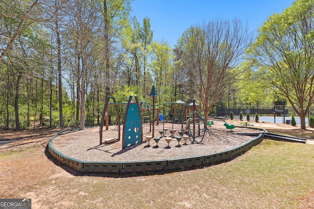 community jungle gym with a yard and fence