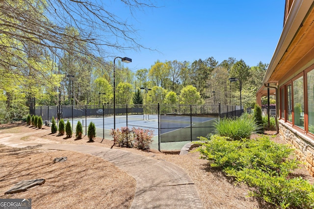 view of tennis court featuring fence