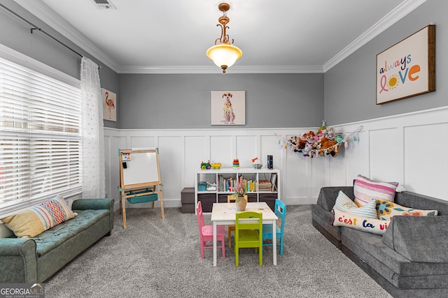 recreation room featuring carpet flooring, wainscoting, crown molding, and visible vents