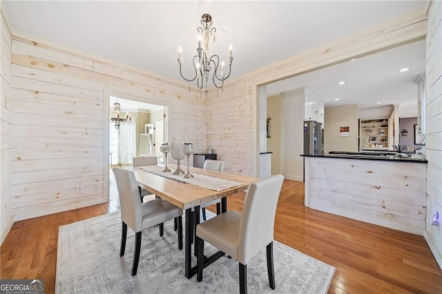 217 Colonial Dr, Woodstock, GA 30189 - dining area featuring a chandelier, light wood-style flooring, crown molding, and baseboards