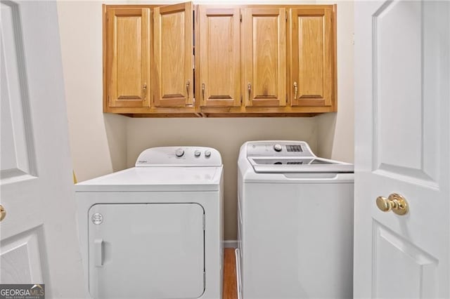 217 Colonial Dr, Woodstock, GA 30189 - clothes washing area with independent washer and dryer and cabinet space