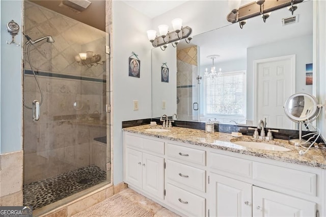 217 Colonial Dr, Woodstock, GA 30189 - bathroom with a shower stall, a chandelier, and double vanity