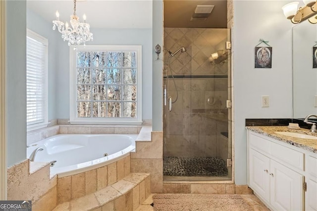 217 Colonial Dr, Woodstock, GA 30189 - bathroom with a chandelier, a bath, a stall shower, and vanity
